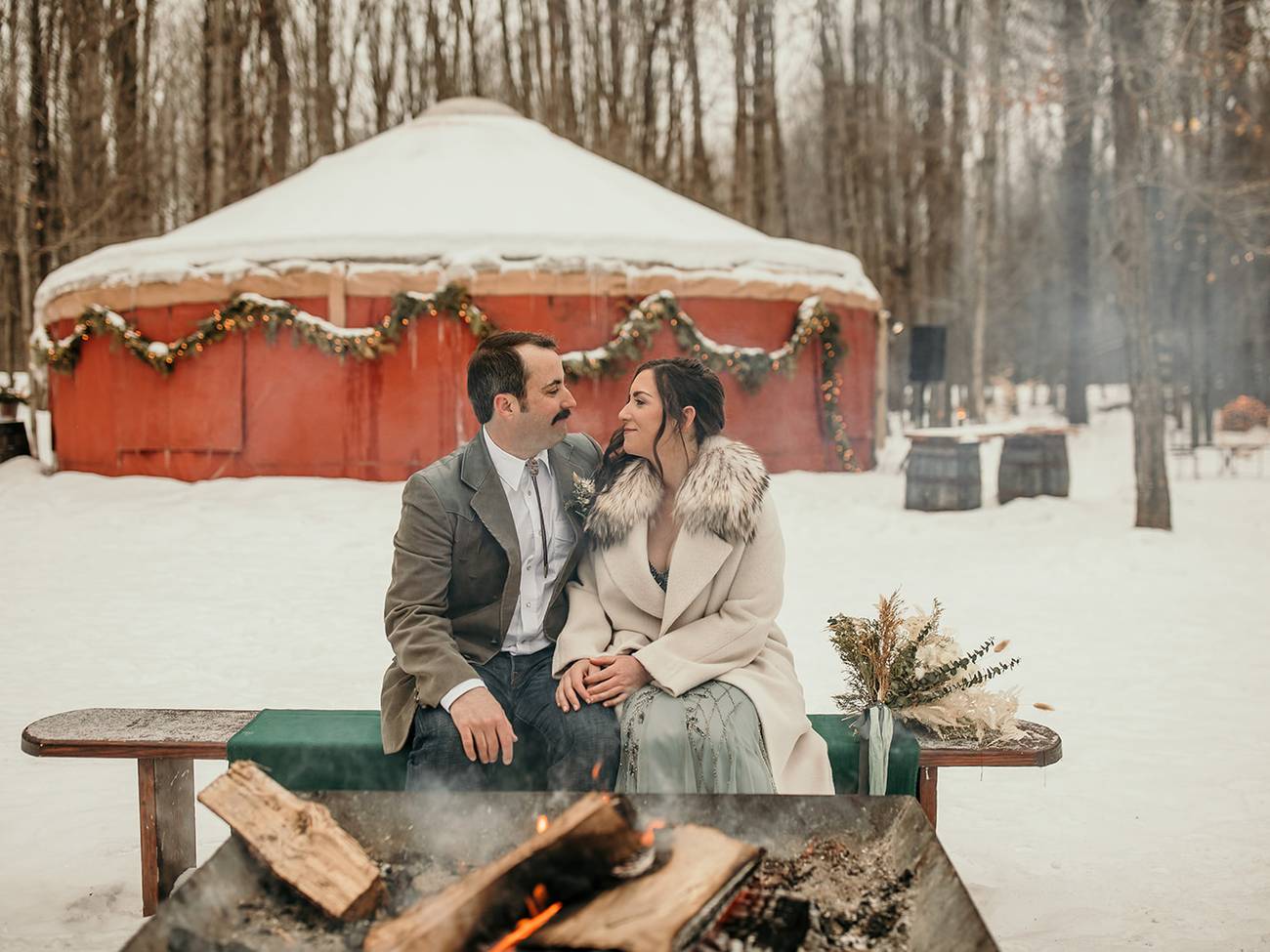 A couple posing near a bonfire