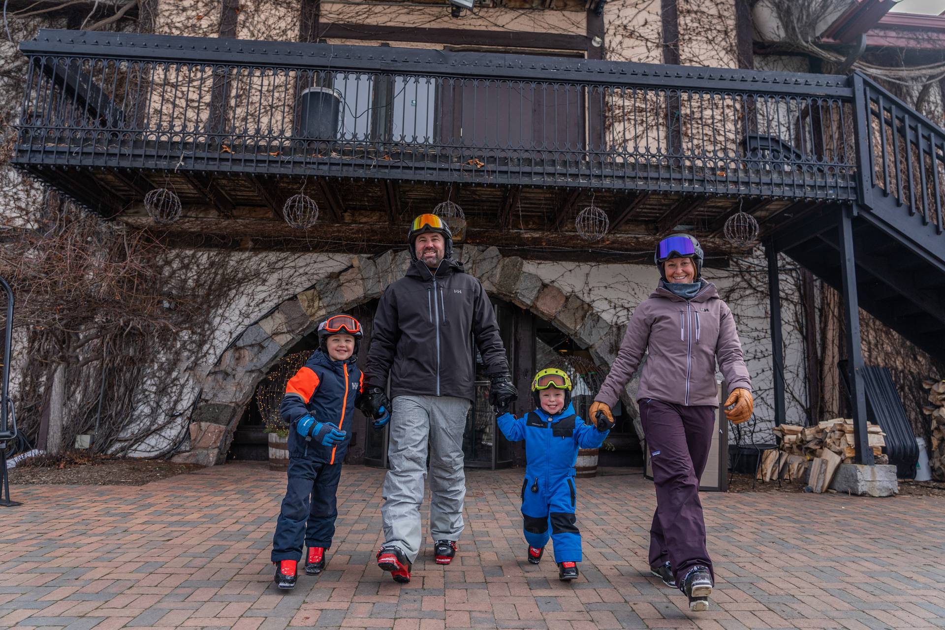 A family in ski gear walking hand in hand