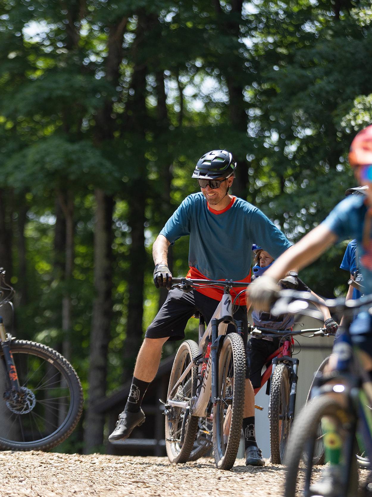 A dad and child in mountain bike gear riding the scenic chairlift