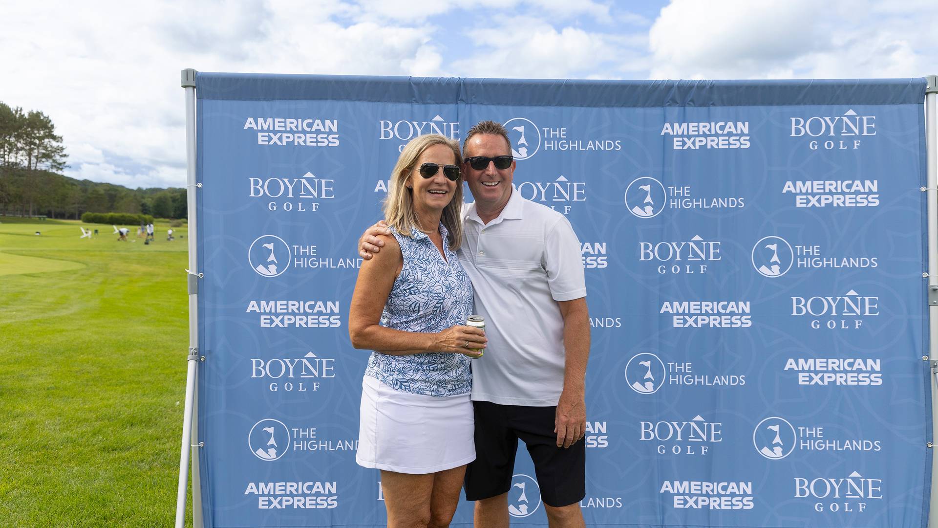 A couple posing in front of a sign