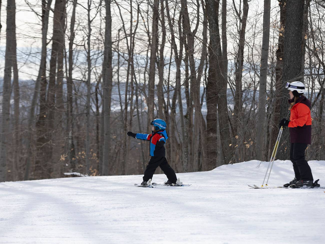 A mom and child skiing