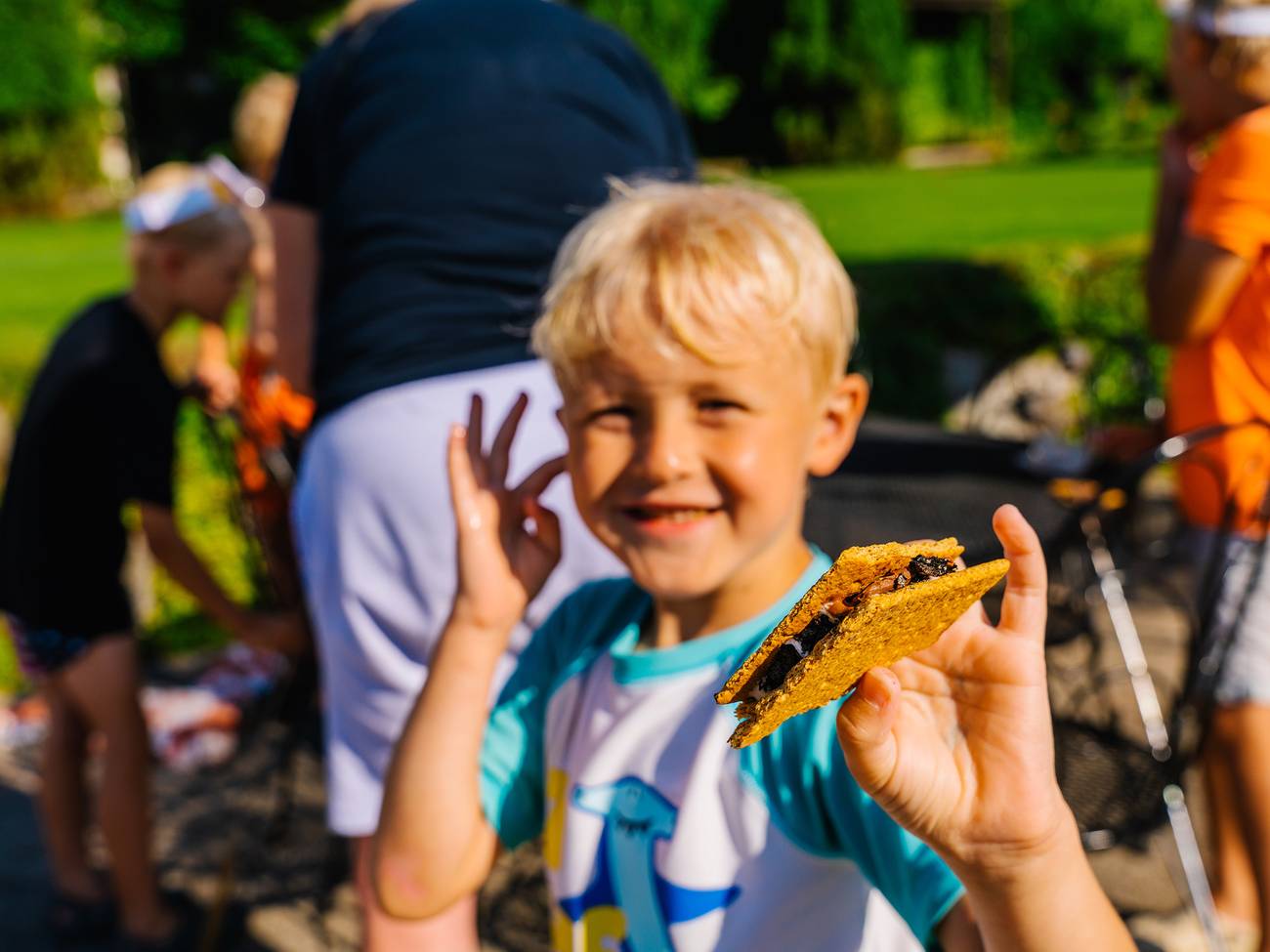 A boy holding a s'more at The Highlands
