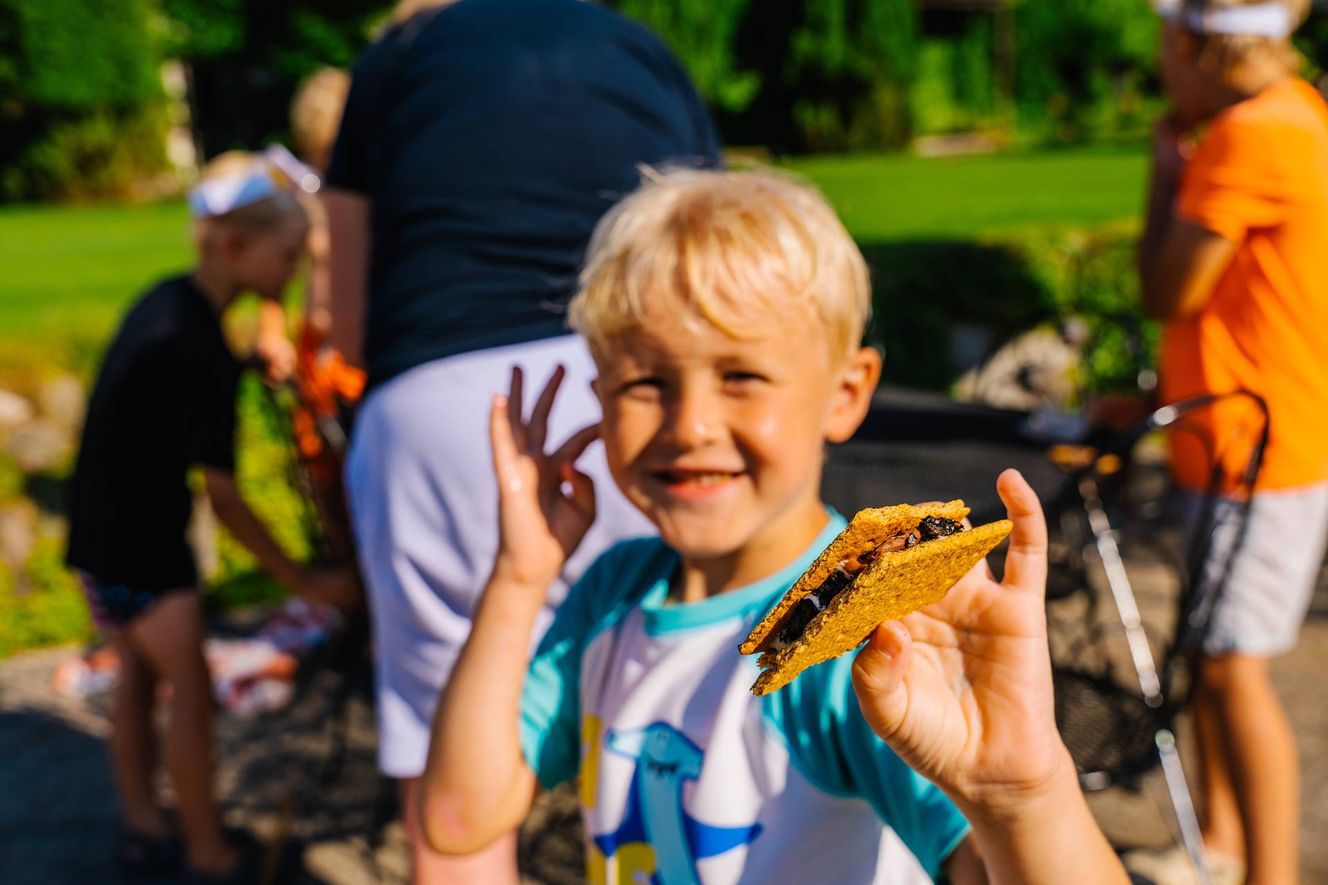 A boy holding a s'more at The Highlands