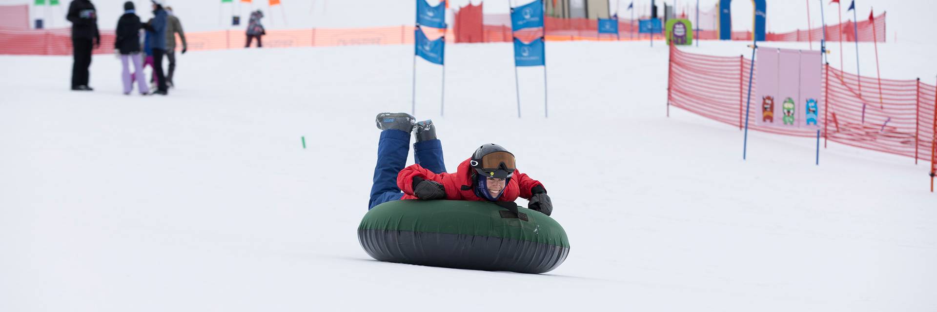 A kid tubing down the hill