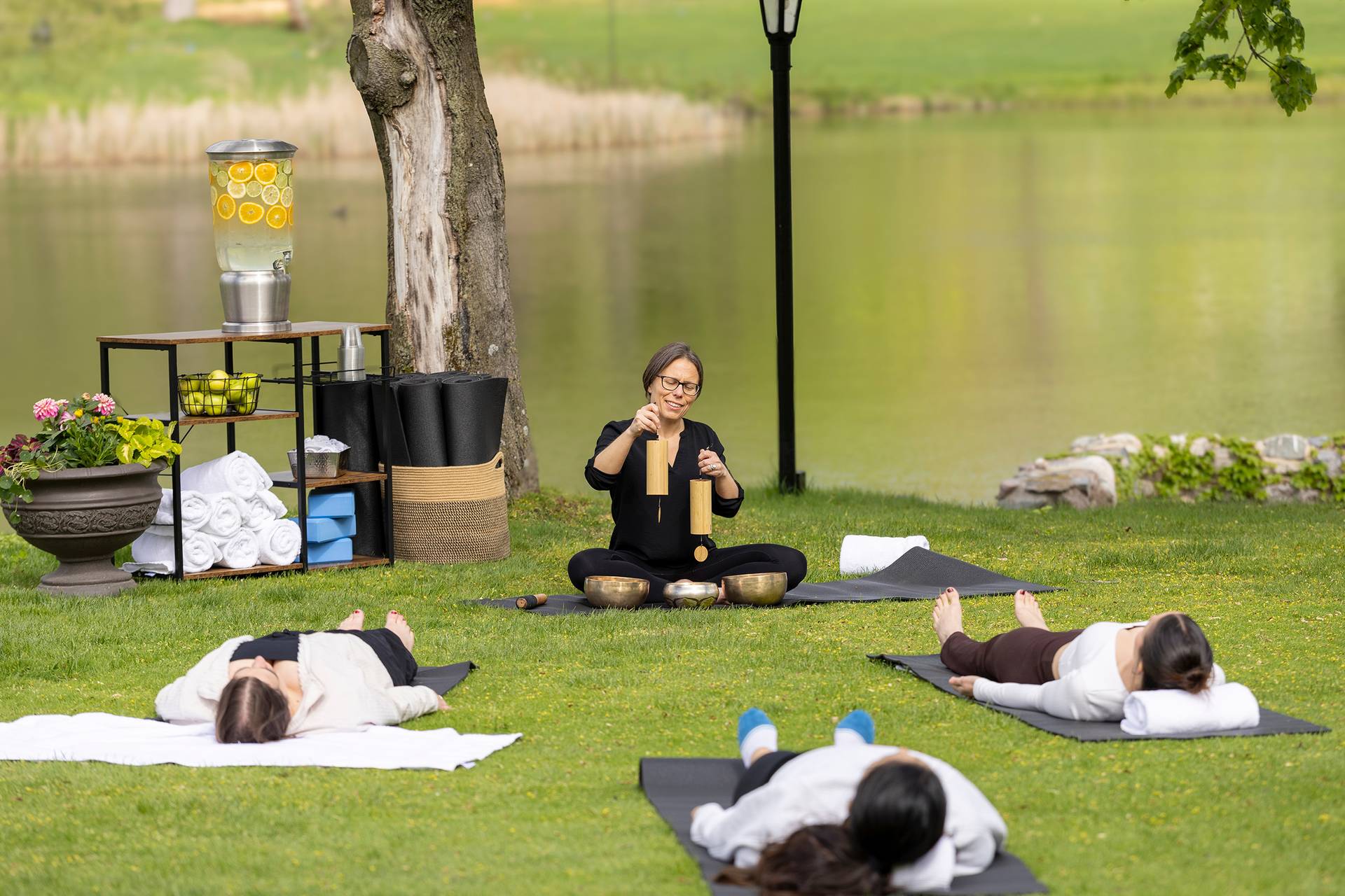 A group participating in a yoga and sound bath class outdoors