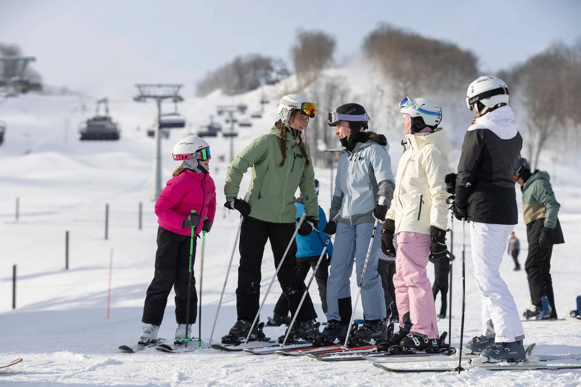 Children in ski gear posing and smiling