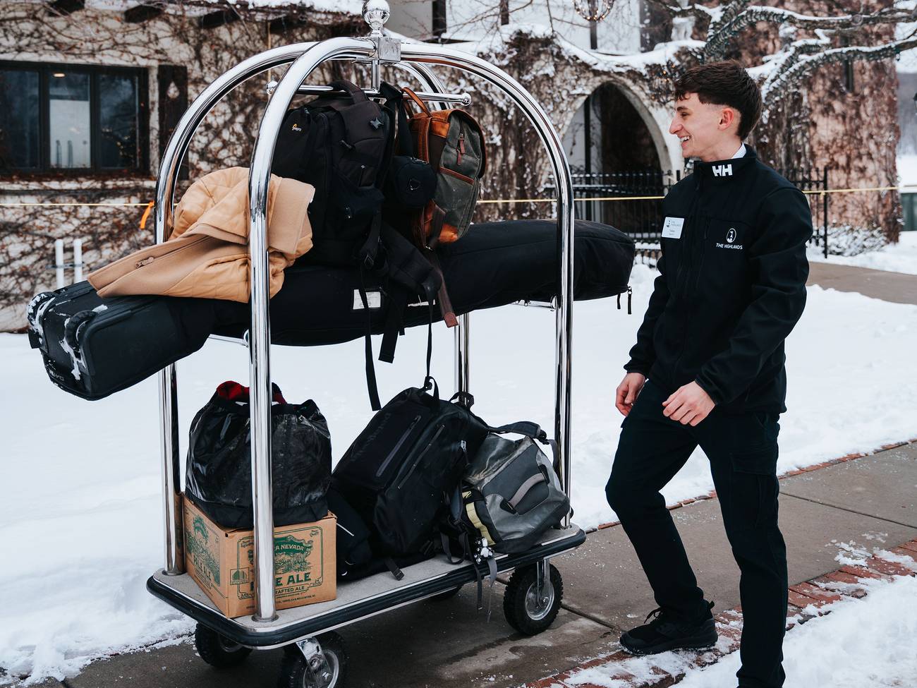 A bell hop in front of the Main Lodge in winter