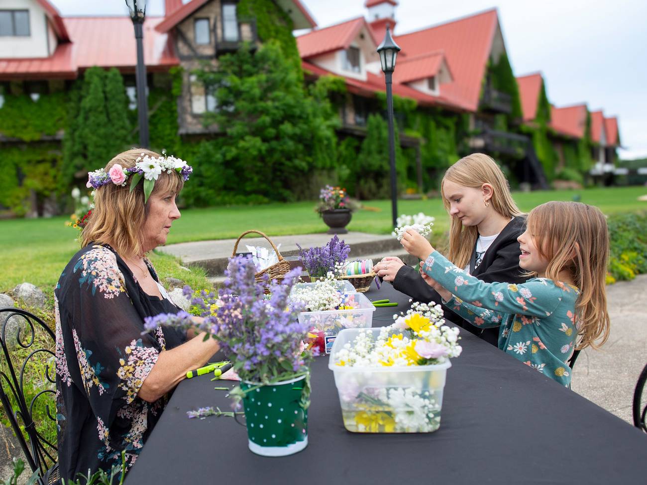 A group doing a flower crown craft on a patio