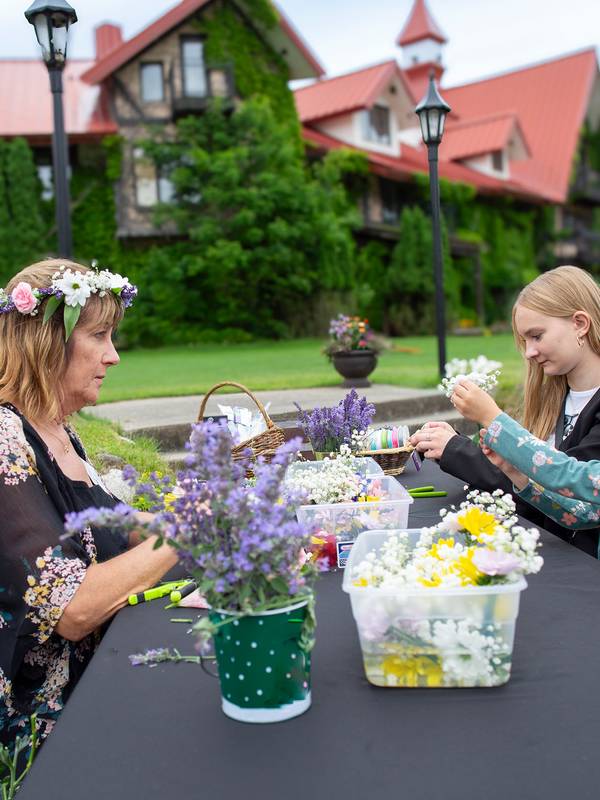 A group doing a flower crown craft on a patio