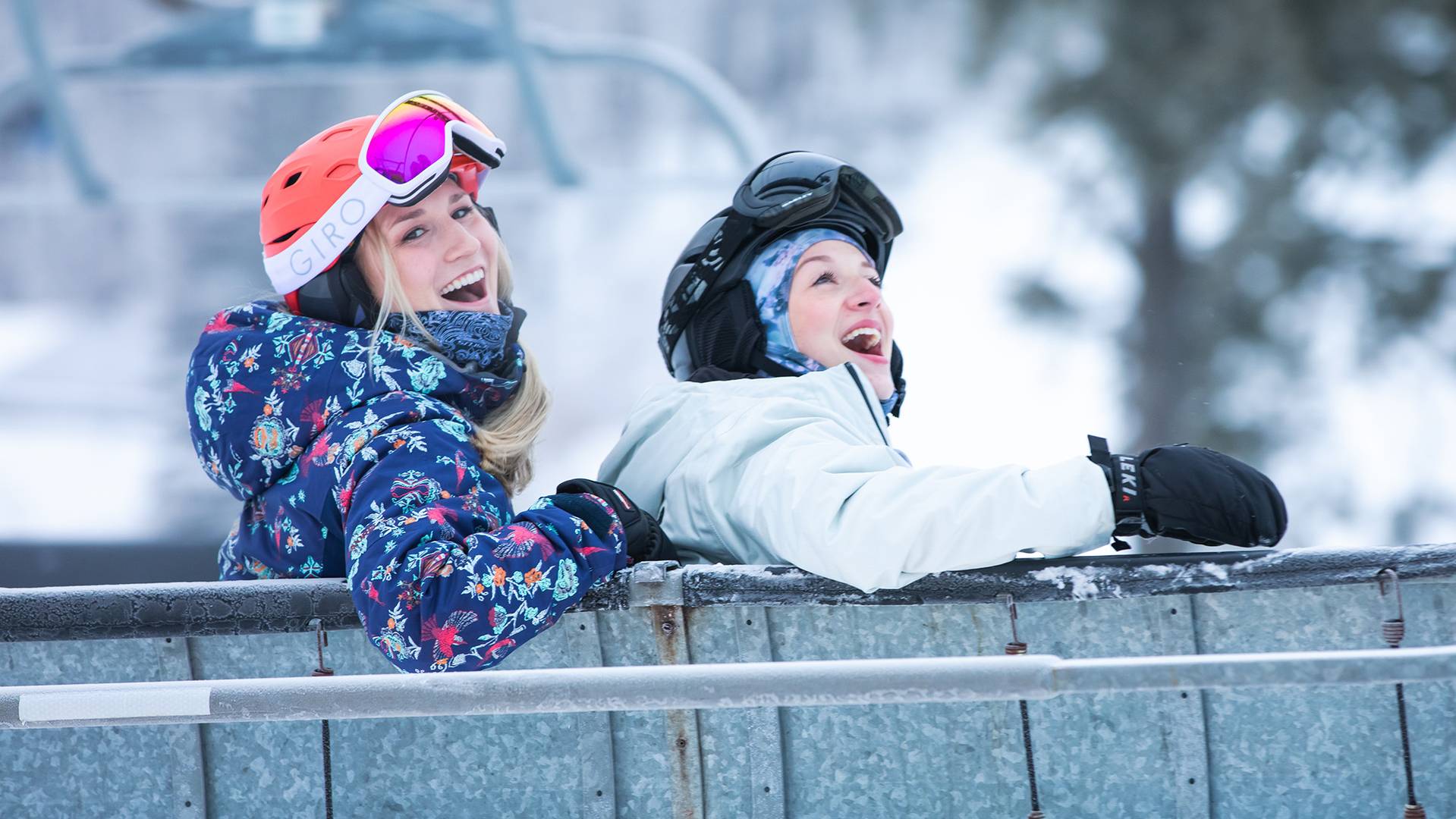 Two women smiling on a chairlift