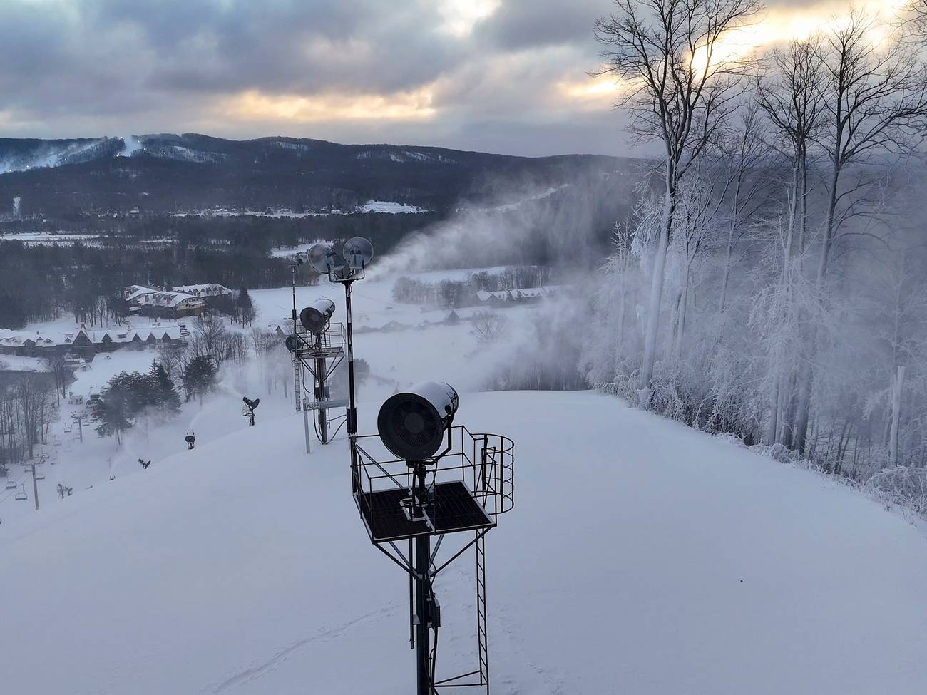A snow gun blasting snow in the morning