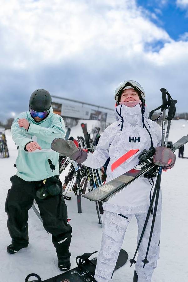 A group of people in ski gear dancing