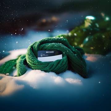 A graphic of a lift ticket card wrapped in a scarf on the snow