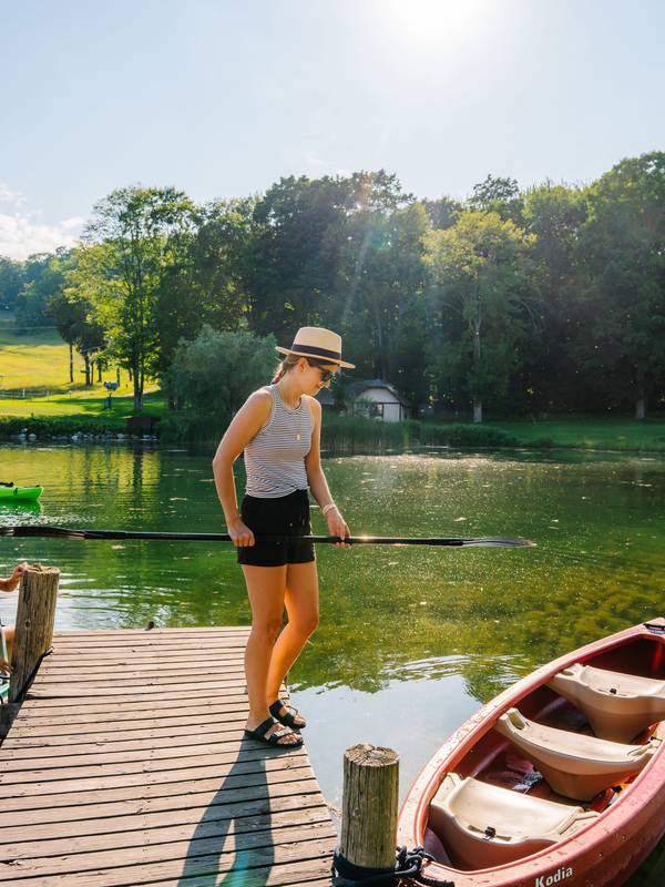 A woman standing near the pond at The Highlands