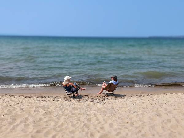 Two people sitting by Lake Michigan at Petoksey State Park