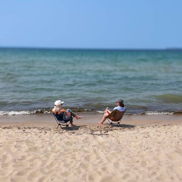 Two people sitting by Lake Michigan at Petoksey State Park