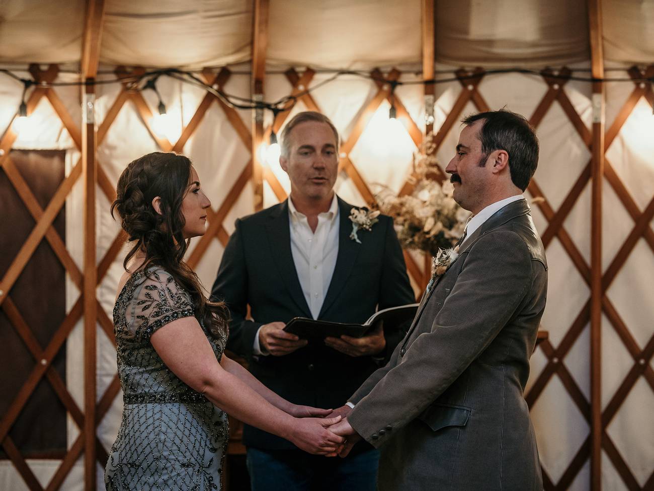 A bride and groom getting married at the yurt
