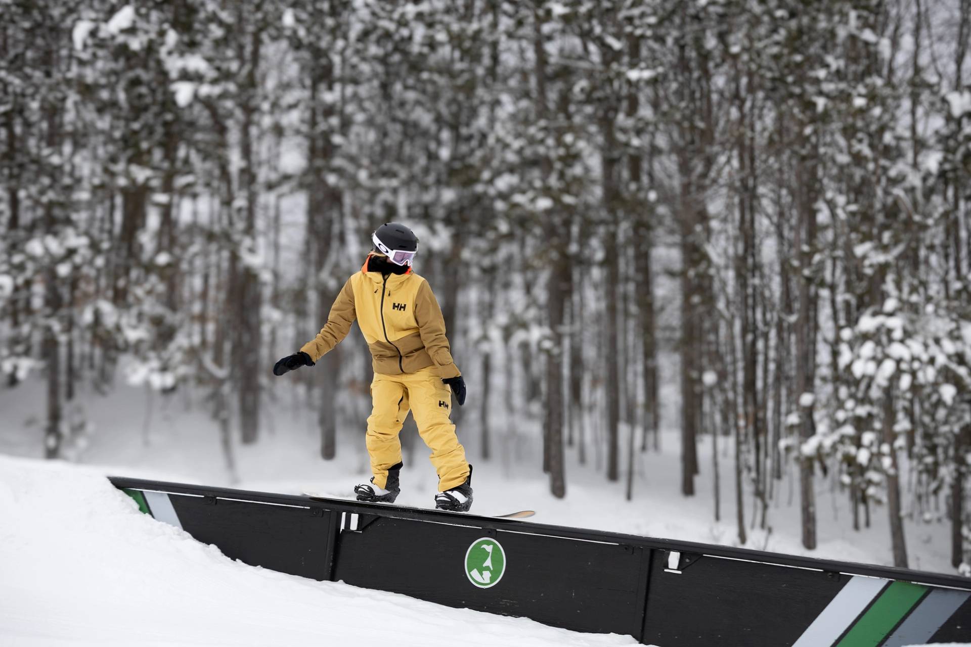 A snowboarder on a box