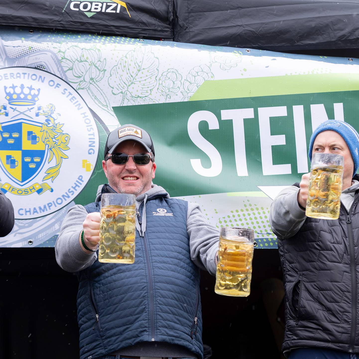 Three men holding beer steins