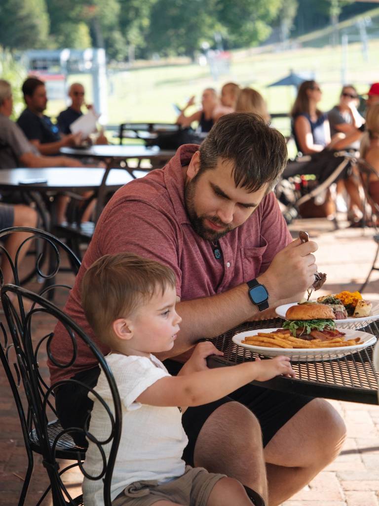 A family eating on the Slopeside Lounge patio