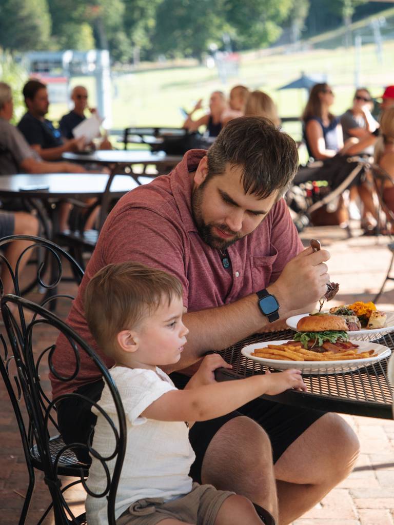 A family eating on the Slopeside Lounge patio
