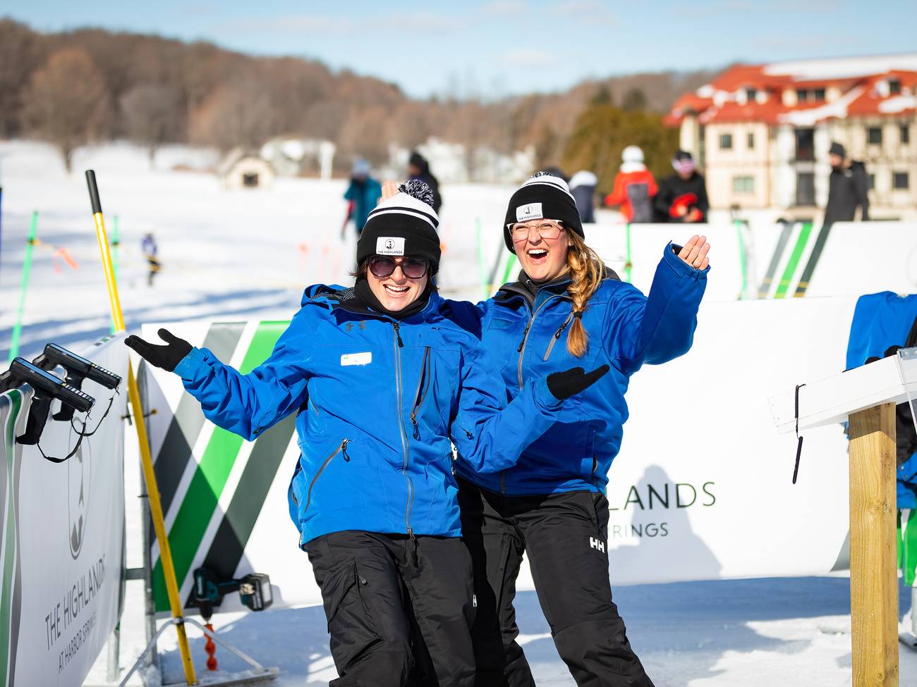 Two employees in winter gear smiling and posing