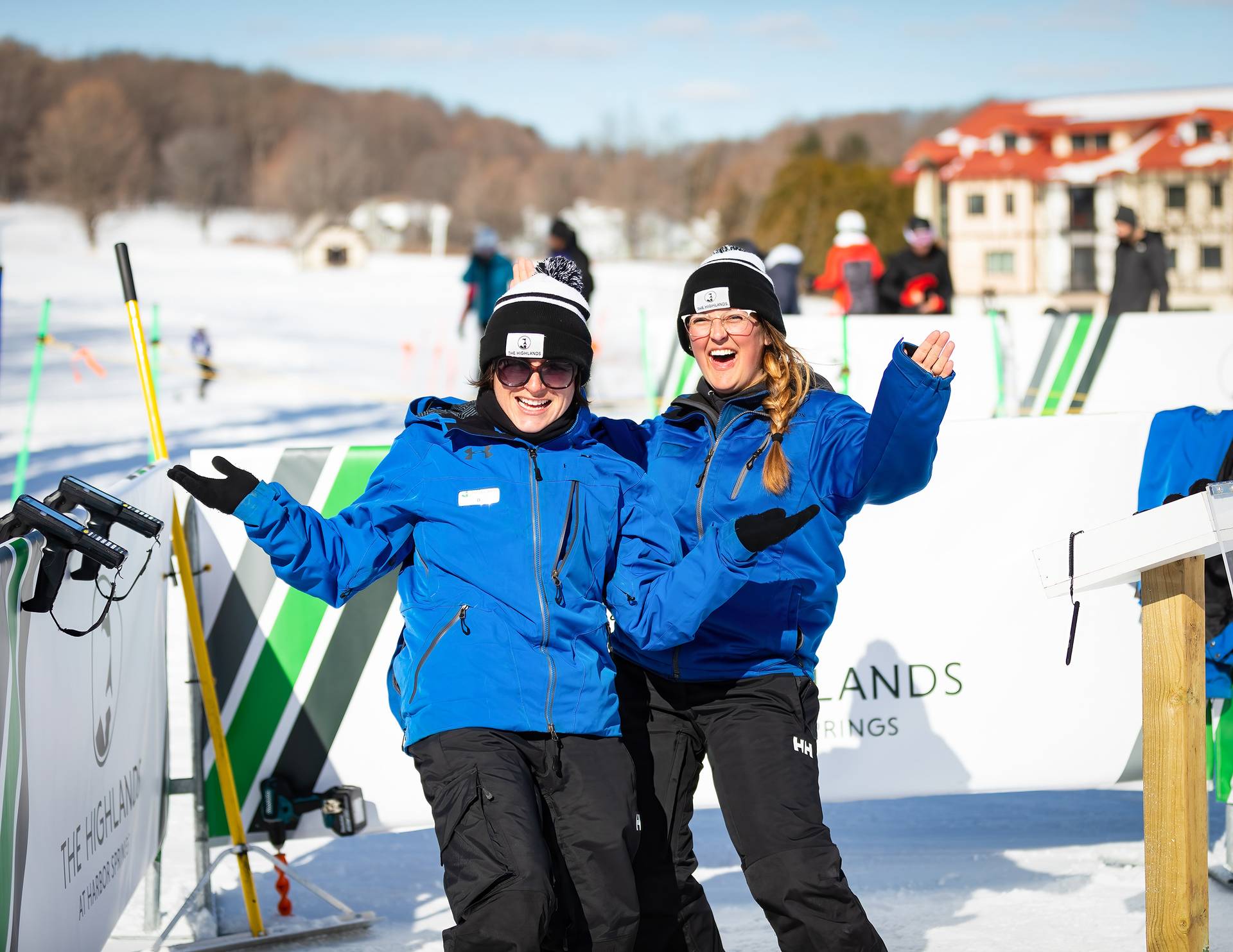 Two employees in winter gear smiling and posing