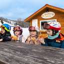 A group of kids eating waffles at the Waffle Cabin