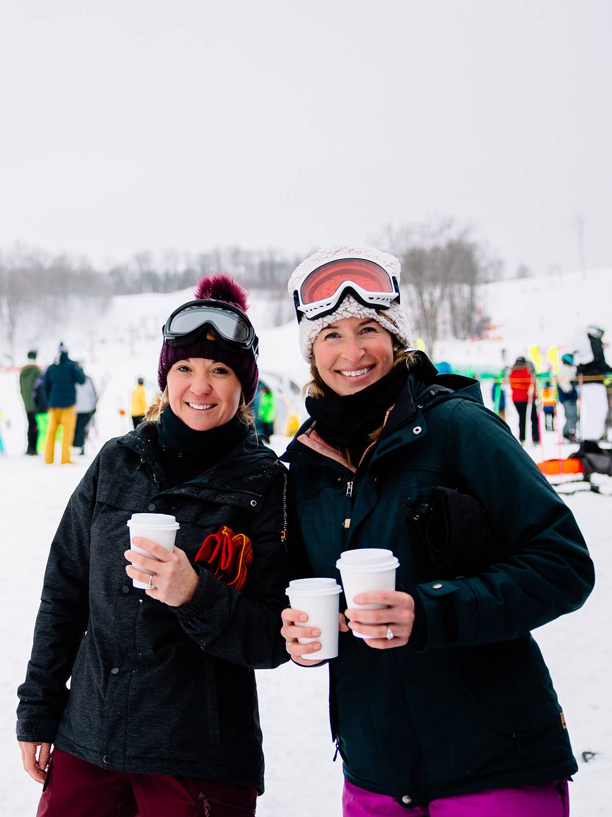 Two women posing with hot chocolate