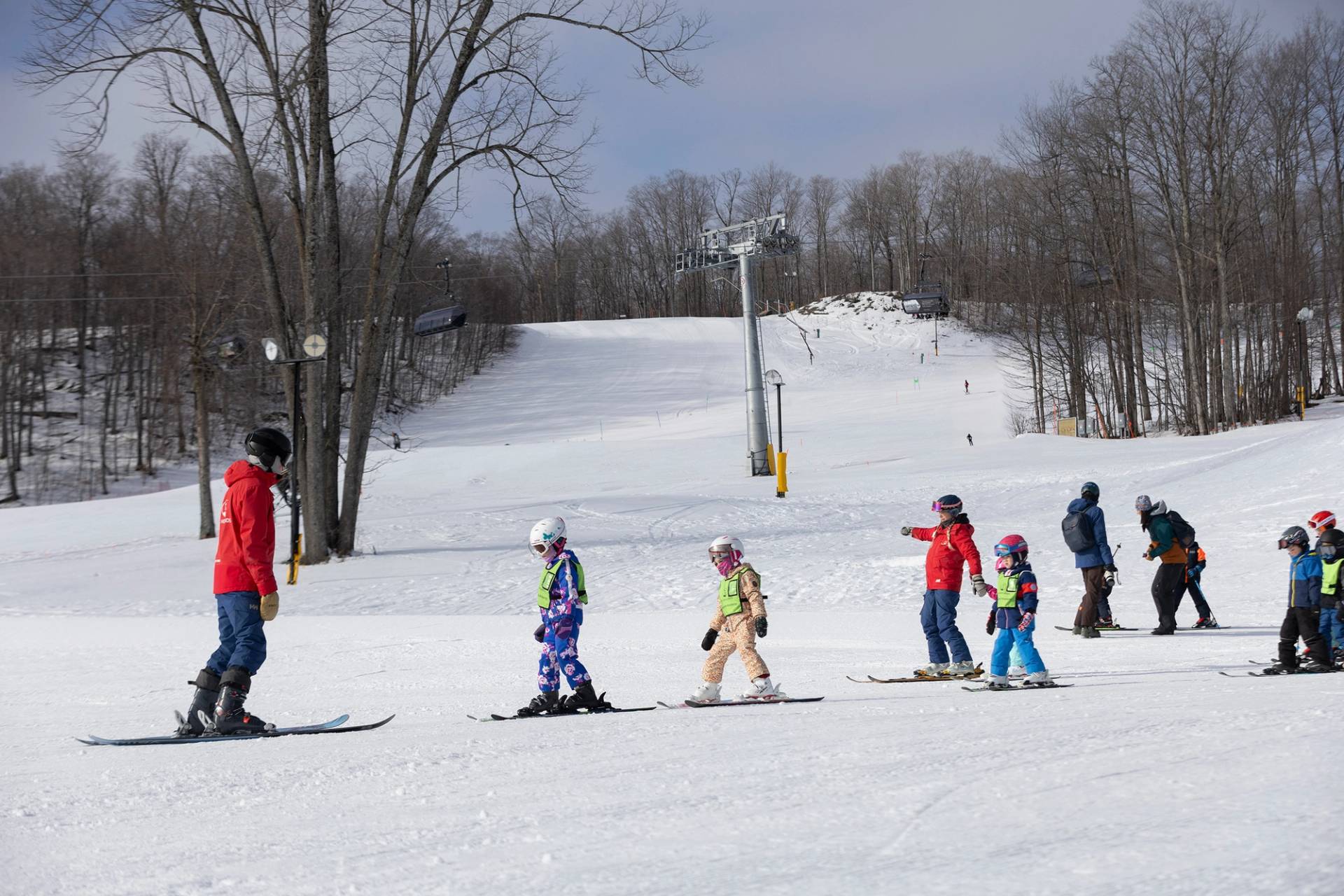 A group of kids taking a ski lesson at The Highlands