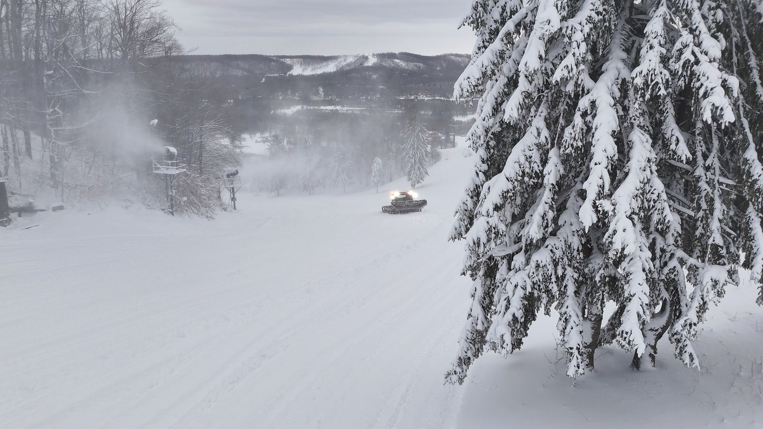 Drone shot of a groomer on the slopes