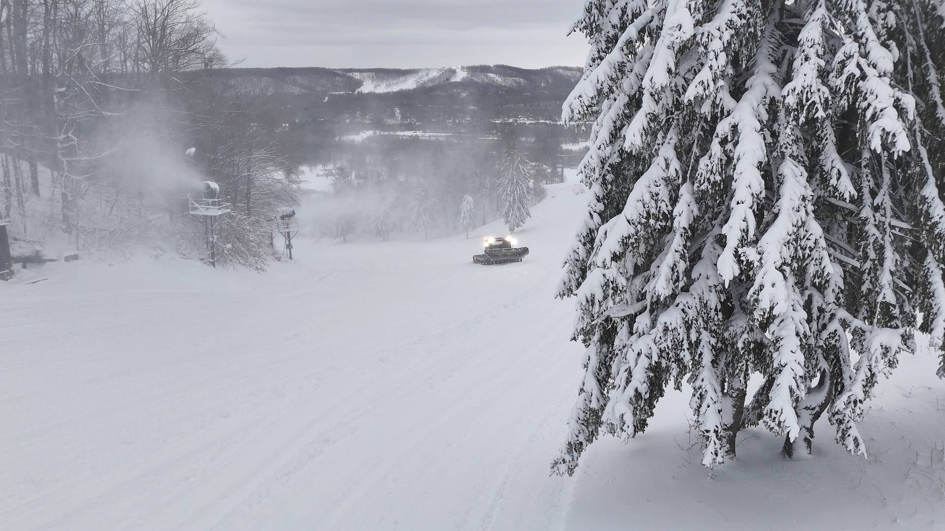 Drone shot of a groomer on the slopes