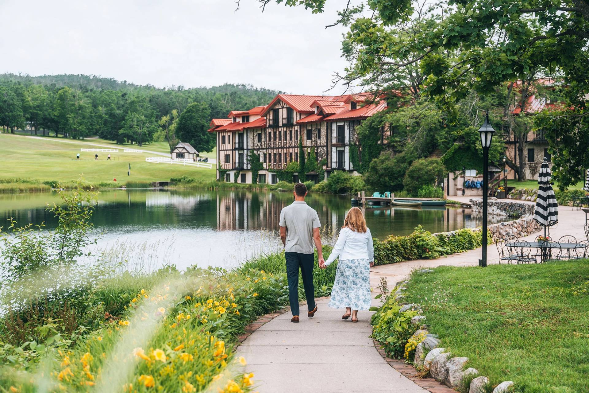 A couple walking near the pond at The Highlands