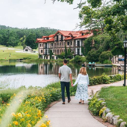 A couple walking near the pond at The Highlands