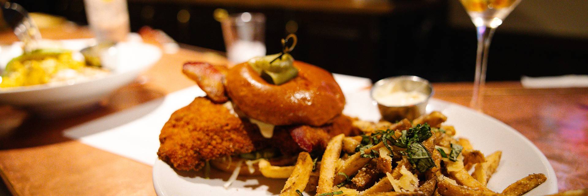 A burger and fries inside Slopeside Lounge at The Highlands