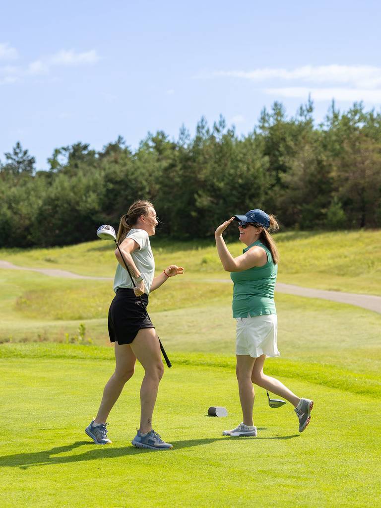 Two golfers giving a high-five