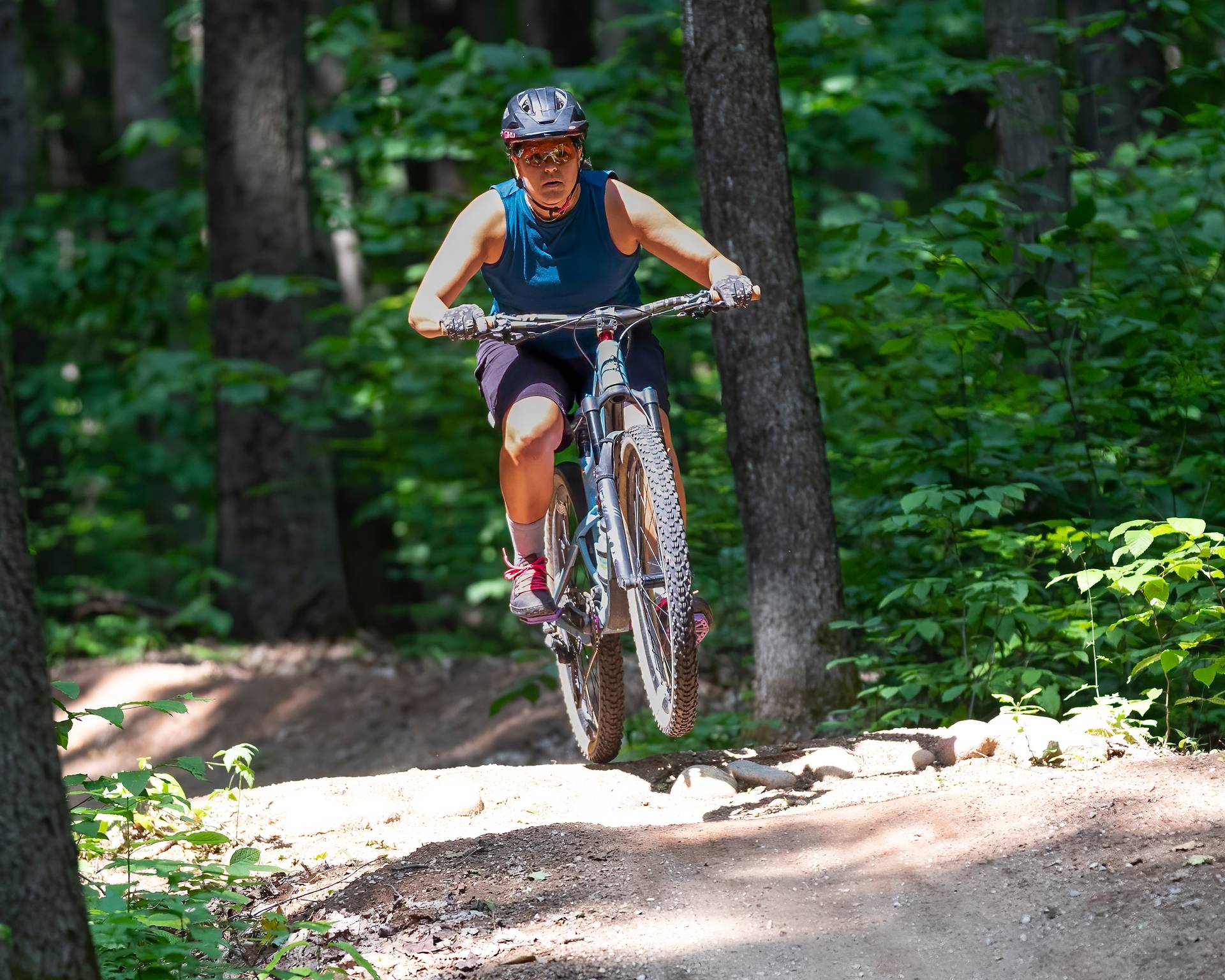 A woman biker on a flow track at The Highlands Bike Park