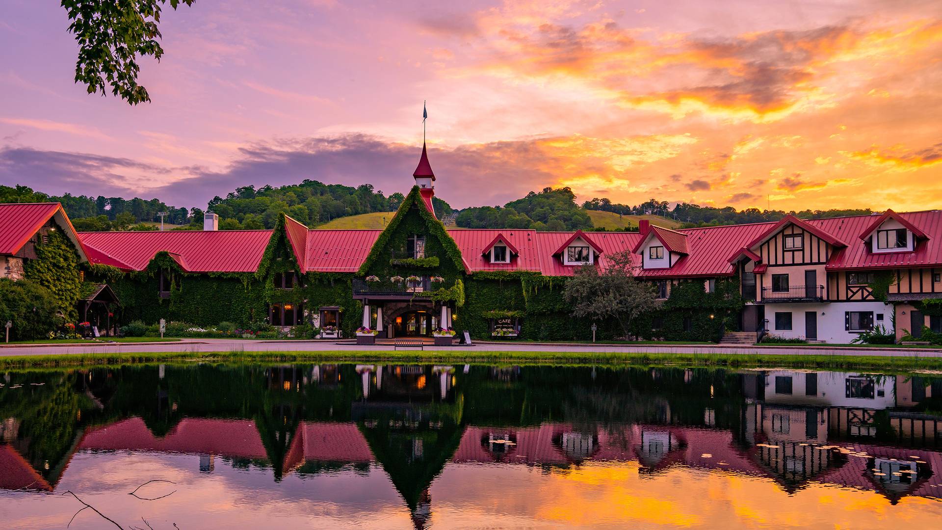 The Main Lodge exterior in summer during a sunset