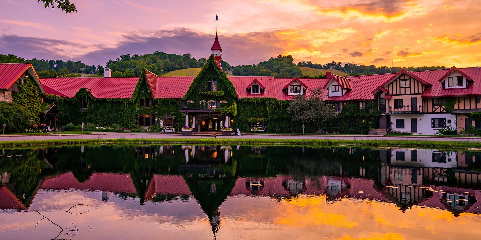 The Main Lodge exterior in summer during a sunset