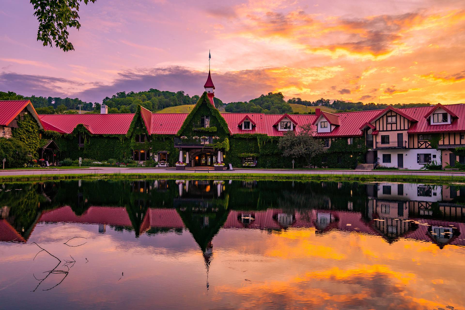 The Main Lodge exterior in summer during a sunset