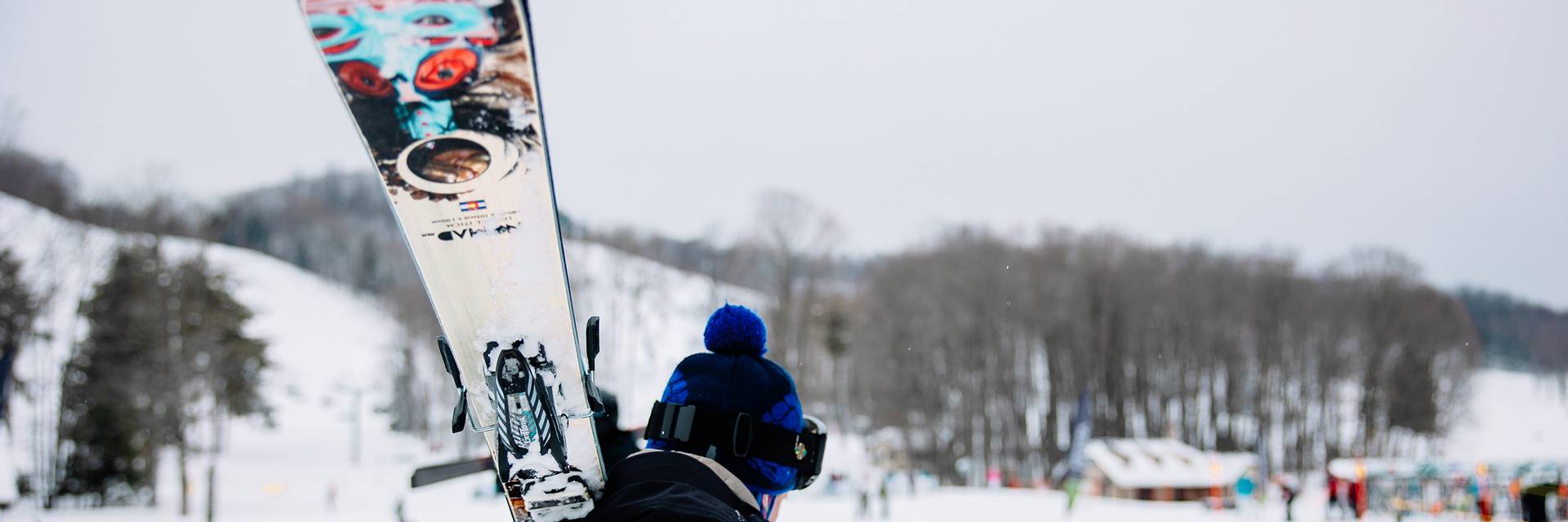 A man carrying skis at The Highlands