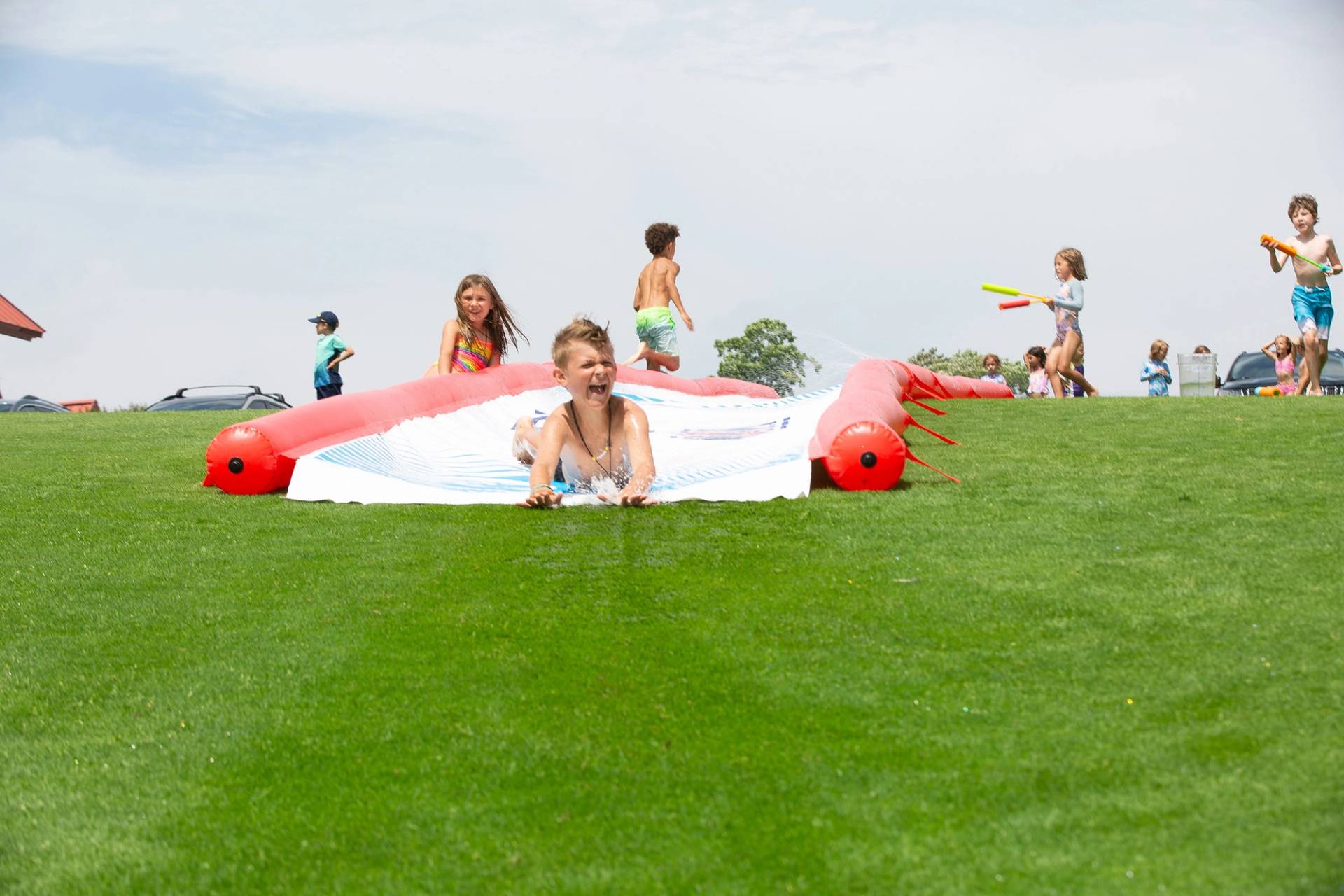 Children playing on a water slide at The Highlands