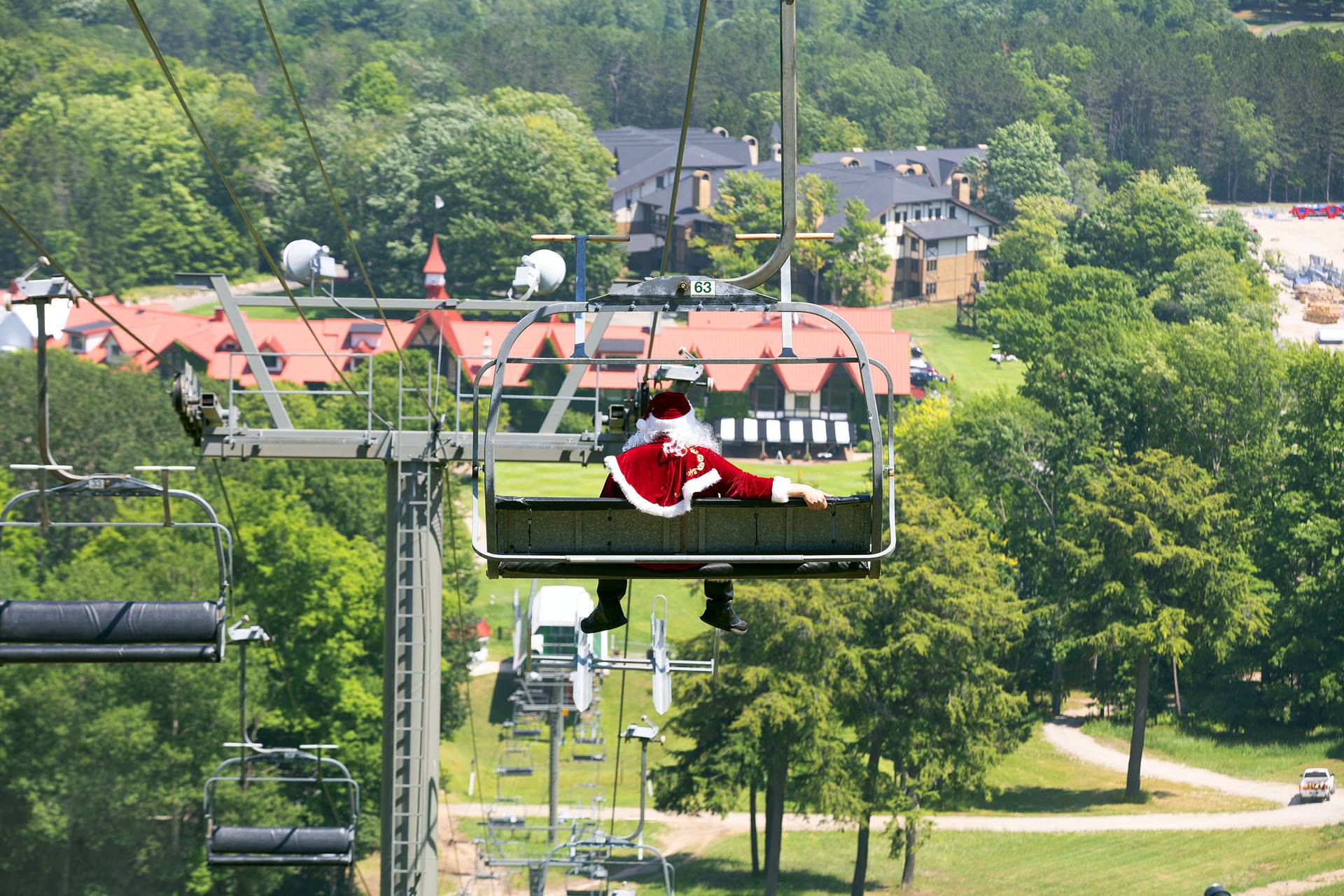 Santa on a chairlift ride in summer at The Highlands