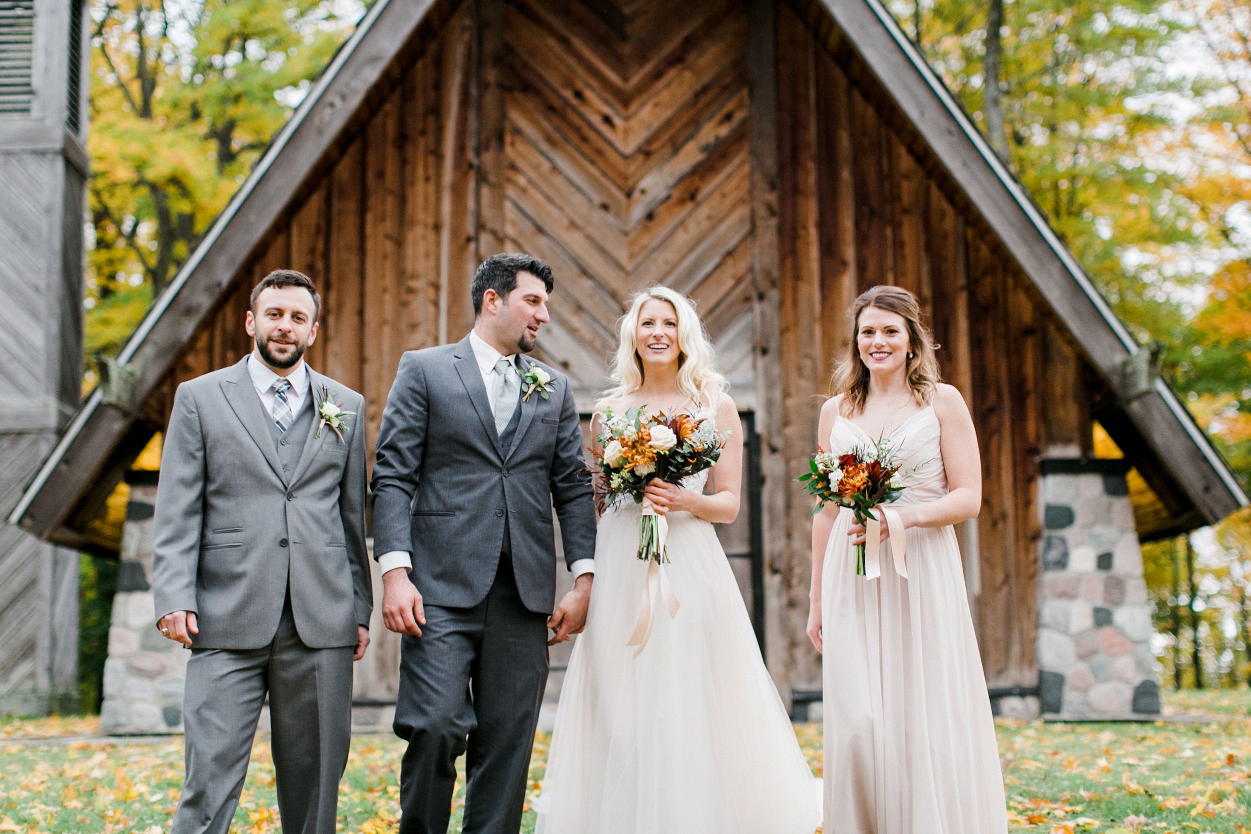 A wedding group posing in front of the Graham Chapel