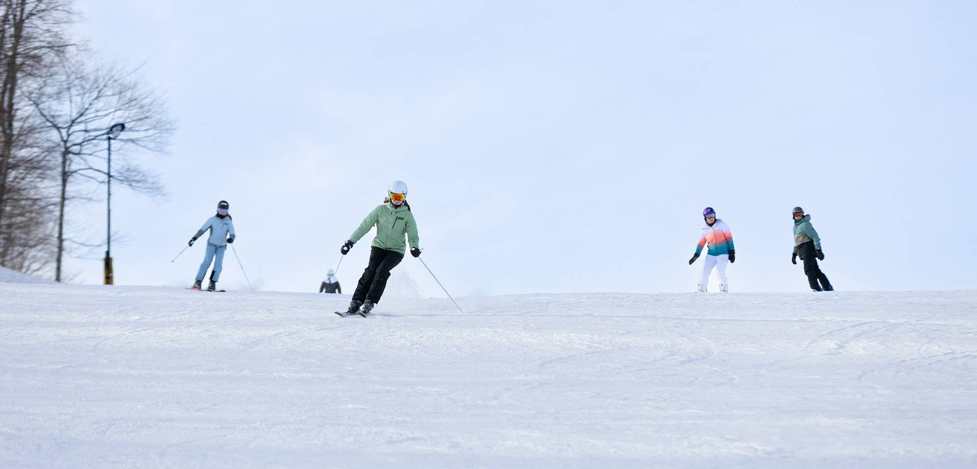 A group of skiers skiing down the slope