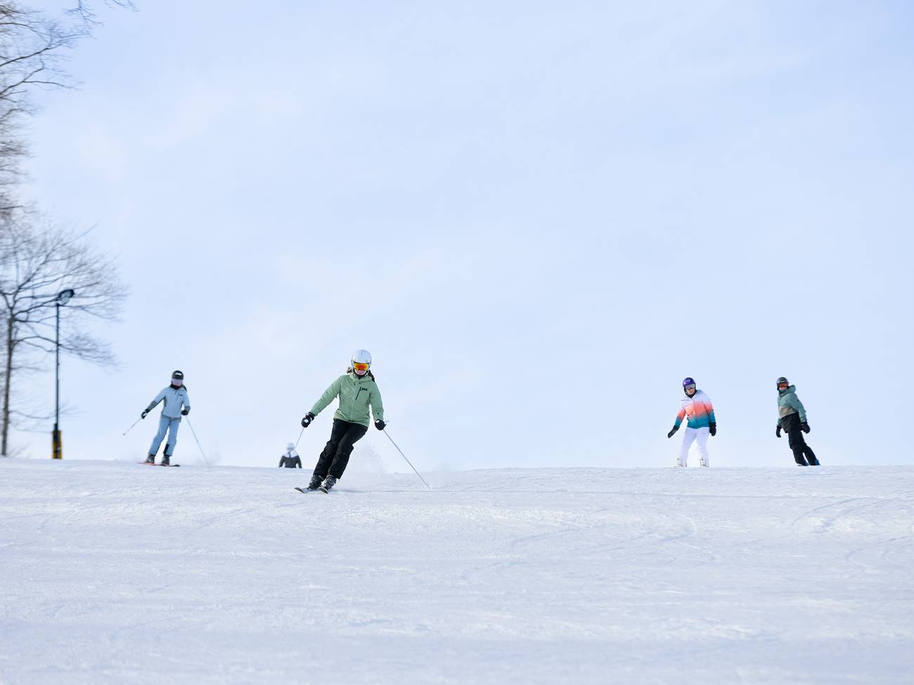 A group of skiers skiing down the slope