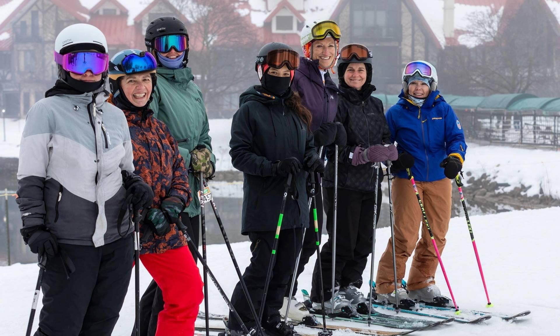 Women posing in ski gear during a Highlands Her Turn Clinic