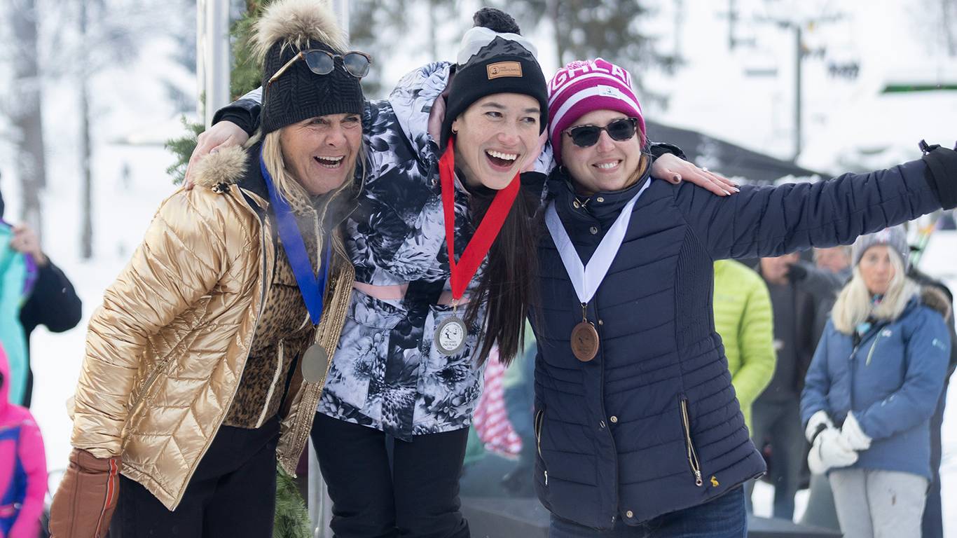 A group of people smiling with medals