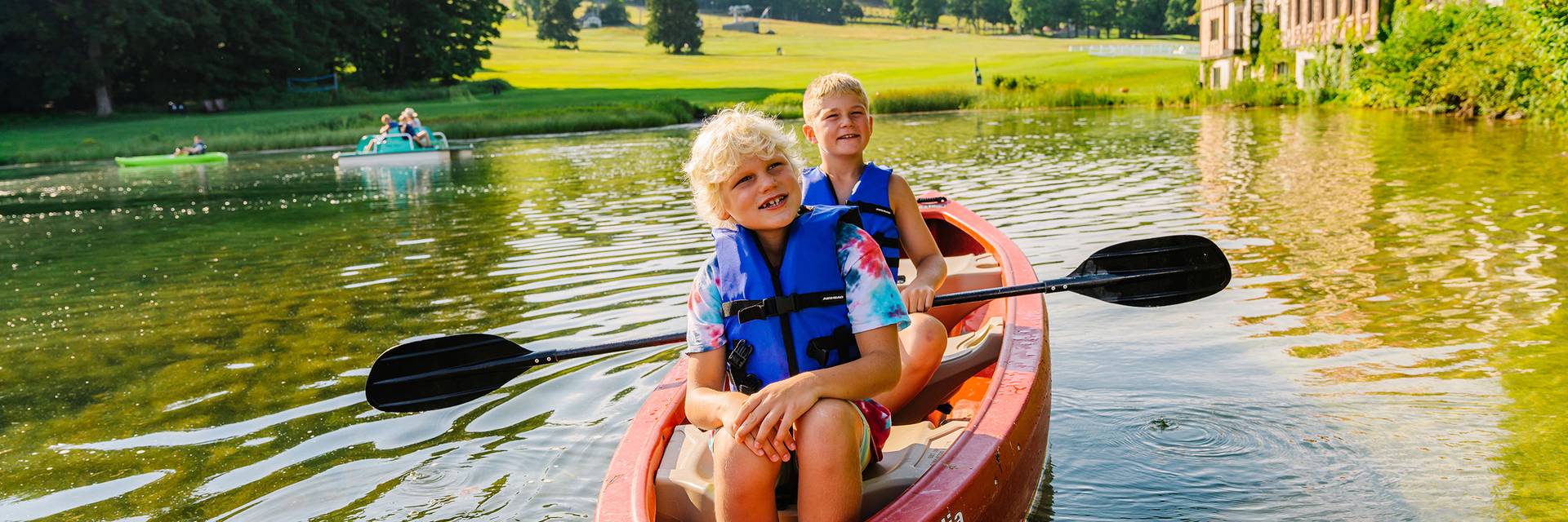 Children in boat on The Highlands pond