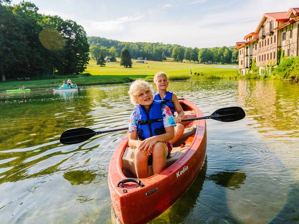 Children in boat on The Highlands pond